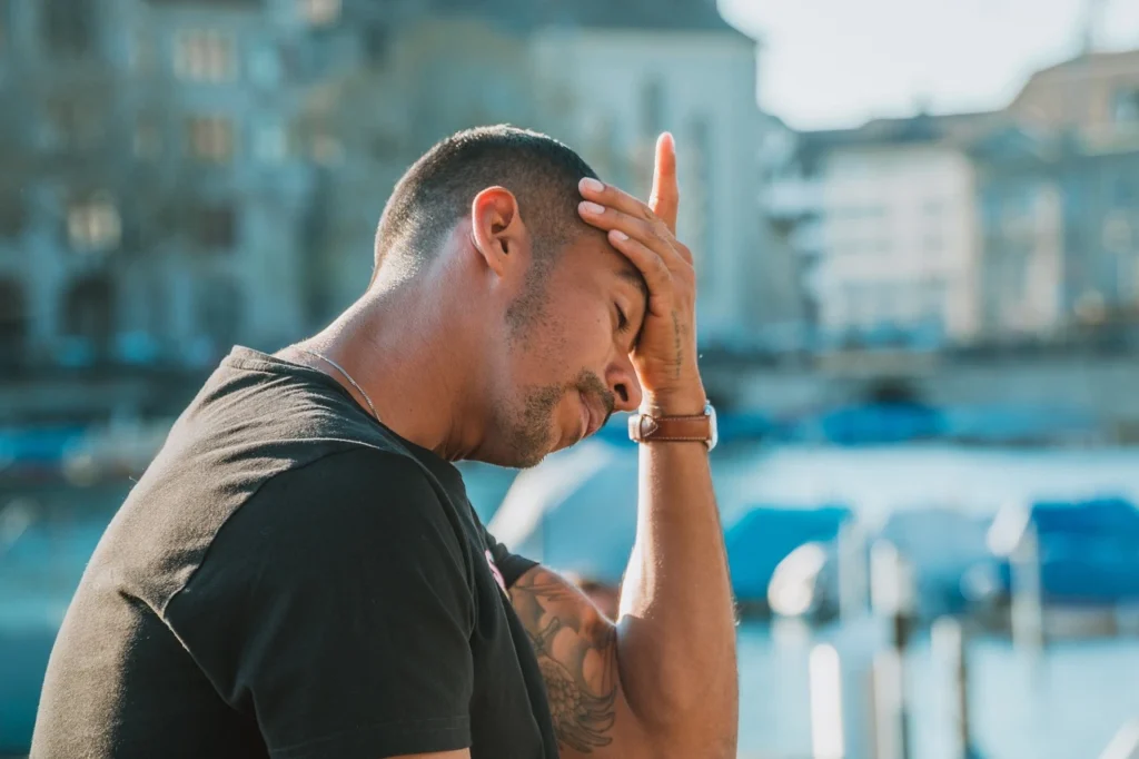 a guy with his hand on his head, because it has a headache